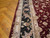 Border detail with black ground, ivory guard stripes, blush rose heads and curling leaf scrollwork