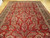 10x18 oversize Persian Sarough rug seen at an angle with detached palmettes and vase motifs