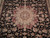 Close-up of the ivory and burgundy center medallion surrounded by palmettes on jet black ground