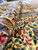 Folded pile detail revealing dense wool nap, ivory ground and red flower heads