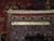 Back of the 11x17 hand-knotted wool rug beside a ruler showing fine knot density