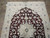 Top half of the rug showing arched palmette crown, scrolling vines and ivory main border