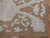 Corner detail showing flat tapestry weave, cream rosette cartouche and plain brown borderless edge