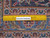 Ruler on the back of the 11x15 Kashan rug proving hand-knotted wool construction and knot density