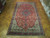 10'8 x 18 Persian Tabriz rug displayed on parquet floor showing full red field and borders