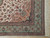 Corner detail of the green main border, guard stripes and ivory cotton fringe on wool silk rug