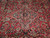 Close-up of aubergine and ivory medallion ringed by pink, teal and cream floral sprays