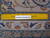 Rug back with ruler confirming hand-knotted wool weave density and authentic handmade Persian construction