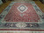 Angled view showing berry red field, sage green spandrels and blossom fan borders in detail