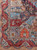 Corner detail showing lion, terracotta vase panels and layered borders on a 10x13 pictorial rug