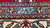 Woven signature cartouche in light blue set into the inner border of this Tabriz rug