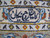 Woven signature cartouche in the ivory border, proof of a signed Persian Kashan workshop rug
