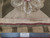 Ruler and Authentic Hand Knotted tag beside the cotton canvas selvage of this Chinese needlepoint rug