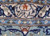 Woven signature cartouche in Persian script set within the navy border of this signed rug