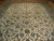 Angled view of the all over floral field with palmettes, curling vines and navy outlines