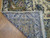 Folded corner showing the hand knotted back, even knotting and ivory fringe of this Persian rug