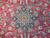 Close-up of the navy medallion, rose rosette center and olive leaves woven in fine wool