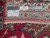 Reverse side showing dense hand-knotted wool weave, ruler for scale and original workshop label