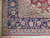 Corner detail with ivory guard border, navy main border palmettes and hand-knotted cotton fringe