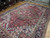 Angled floor view highlighting maroon field, ivory corner spandrels and teal blue serrated leaf drawing