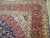 Folded corner revealing multiple guard stripes, ivory spandrel and dense 3/8 inch Persian wool pile
