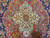 Macro of medallion core showing 8 petal rosette in ivory, sky blue and rust tones