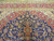 Upper field and border with red pendant, ivory spandrel scrollwork and flowering vines on navy