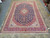 Overhead photograph of the complete 1970s Persian Kashan rug in navy, red, ivory and green