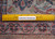 Reverse side with ruler measuring knot count, confirming authentic hand-knotted wool construction and craftsmanship