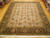 9' x 11'6" hand-knotted Persian wool rug displayed flat on hardwood showroom floor