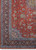 Corner detail with mid blue spandrel, ivory vine border and hand-knotted red orange floral field
