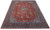 10x13 Persian Sarouk rug displayed at an angle, navy main border and gold medallion visible