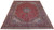 Angled full view of a red 10x13 Kashan rug showing ivory spandrels and navy borders