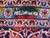 Woven signature cartouche in the light blue guard border of this signed Persian Kashan rug