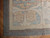 Corner showing wide ivory acanthus border, pewter outer band and hand-plied cotton fringe