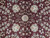 Close-up of ivory rosettes, olive leaves and rose blossoms knotted in silk on burgundy ground