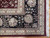 Corner detail showing black main border, ivory guard stripes, palmette motif and white cotton fringe