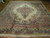 Angled view of large hand-knotted wool Kazvin rug with cream ground and blue floral borders