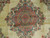 Close-up of layered rose medallion with gold interlace, teal cloud bands and coral rosettes