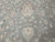 Sage green field close-up with ivory palmettes, vine scroll and small red flower accents