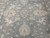 Detail of all over floral pattern, cream rosettes and leafy vines across the green field