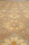 Angled pile view showing saffron gold petals, rust outlines and the low even wool clip