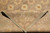 Folded corner of the wool rug showing pile depth, sage field and ivory fringe end