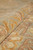 Rolled edge close-up revealing dense hand-knotted wool pile and the soft muted Chobi palette