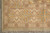Corner view of 8'8" x 11'8" Ziegler rug with fringe, guard stripes and diamond medallions