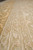 Border guard stripes with small ivory blossoms viewed at floor level along the rug edge