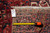 Back tag marked rug number F-4599 beside a tape measure on the hand-woven reverse