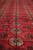 Field detail of the 8x11 Bokhara rug with repeating guls and fine hand-knotted wool pile