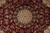 Central medallion detail with black halo, rose sprays and mirrored vinework on burgundy ground