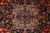 Detail of the 8 petal rosette medallion center in blue, ivory, rose and crimson wool